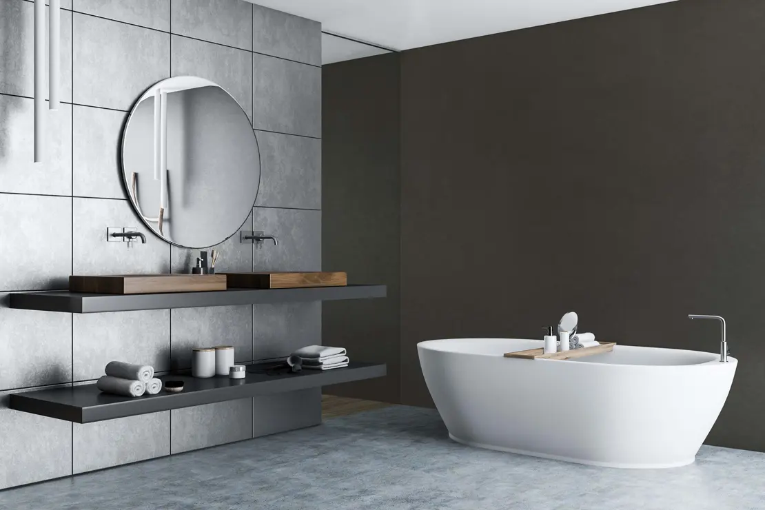 Baño con muros de microcemento de tonalidad gris oscuro.